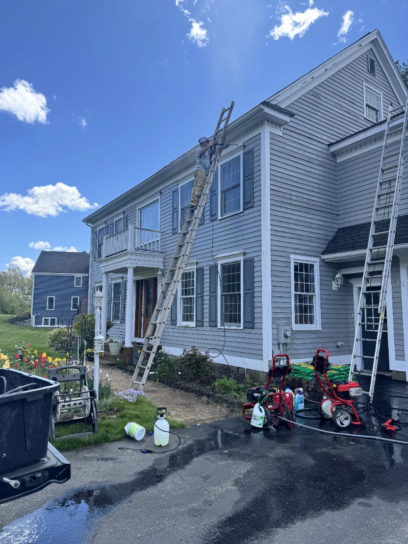House Painting power washing a home exterior before repainting